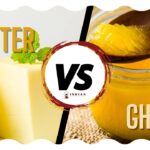 Spoonful of golden desi ghee with a blurred Indian kitchen background.