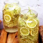 Freshly picked elderflower heads on a wooden table