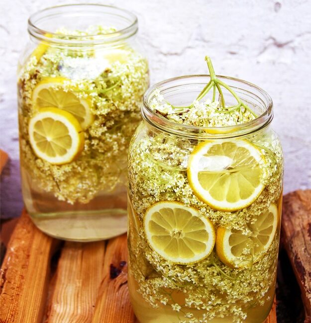 Freshly picked elderflower heads on a wooden table