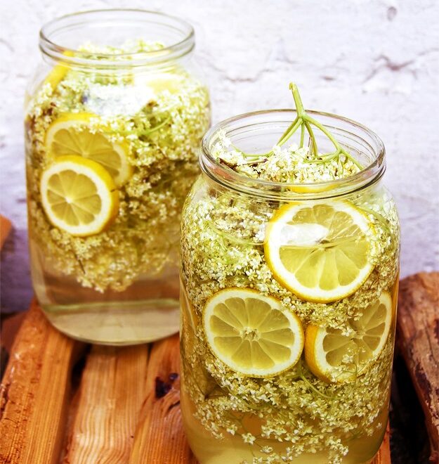 Freshly picked elderflower heads on a wooden table