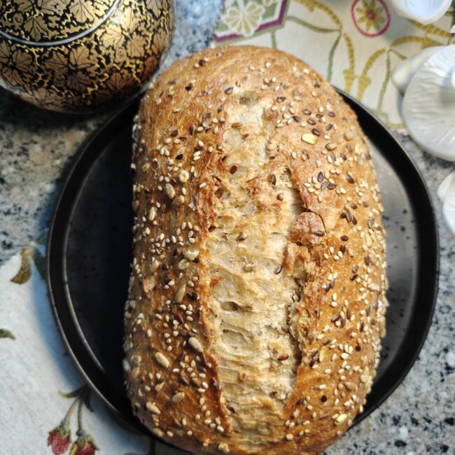 Homemade sourdough seeded bread loaf with golden crust and artisan texture